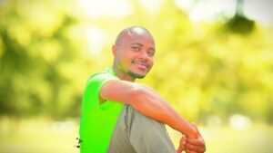 The assurance of our salvation | Our predestination 3 A very handsome light skin man smiling, he is wearing a green shirt and a grey trouser